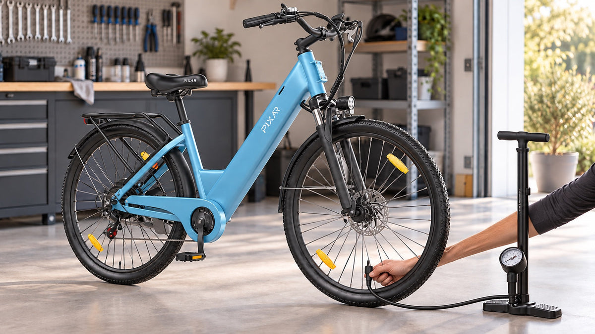 Blue PIXAR C1 electric bike with a floor pump connected to the front tire for a pressure check